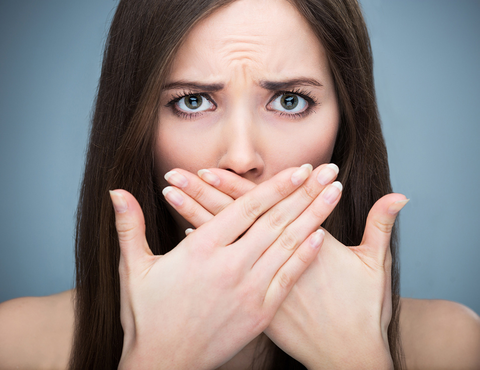 Woman covering mouth